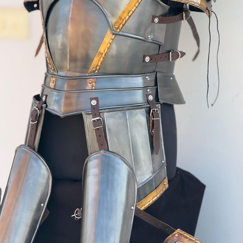 Full armor kit laid out including cuirass, greaves, gauntlets, and pauldrons