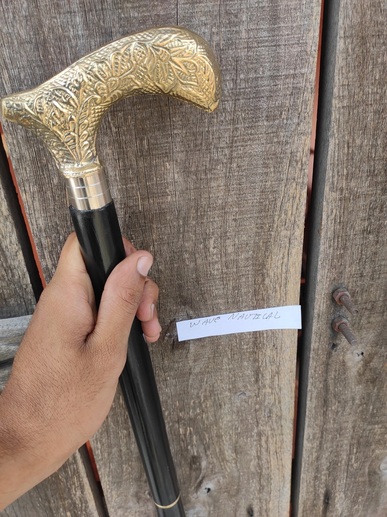 Engraved Derby Handmade Walking Stick resting on wooden stand