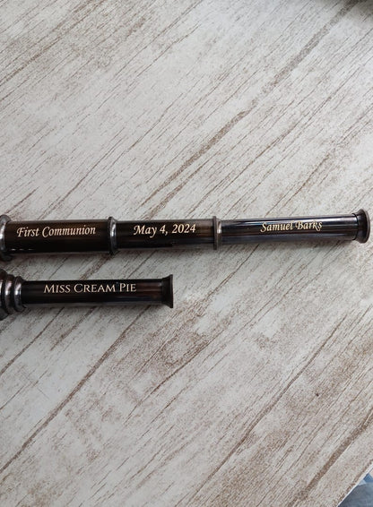 Engraving options shown on three sides of brass telescope
