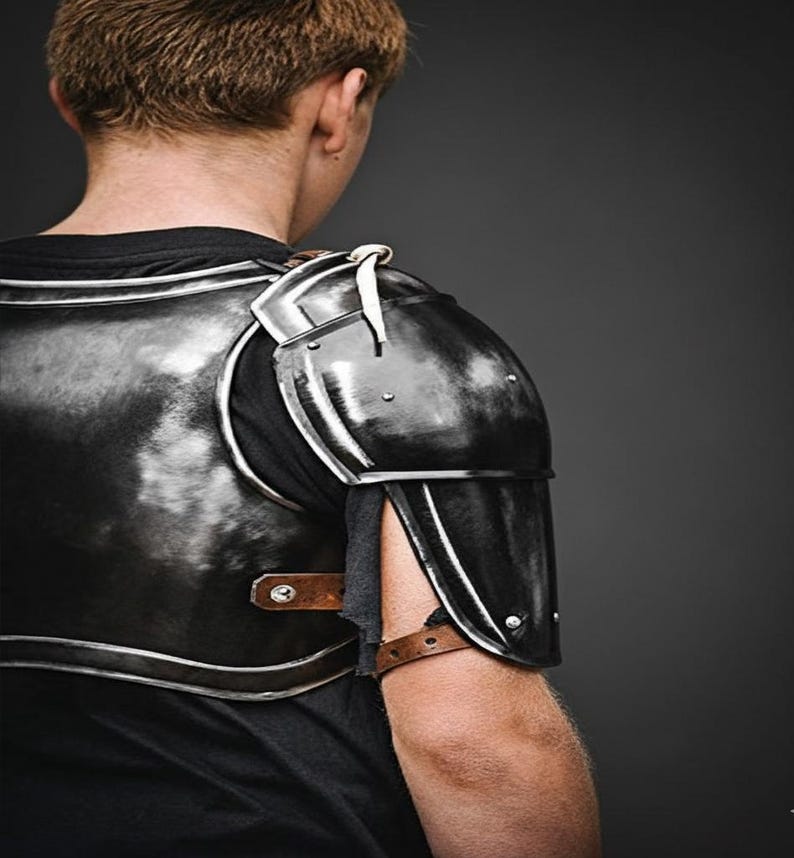 Hand-forged blackened steel armor with rugged patina texture