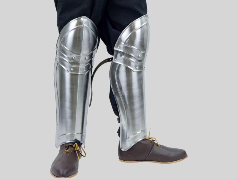 Handmade Polished Steel Knight Greaves shown as part of full medieval armor set