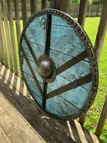 Close-up of handmade Viking battle shield showing metal fitting details