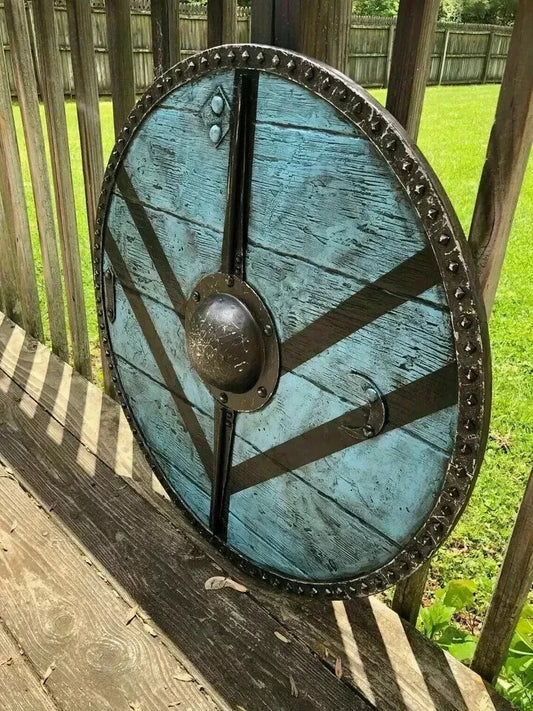 Close-up of handmade Viking battle shield showing metal fitting details