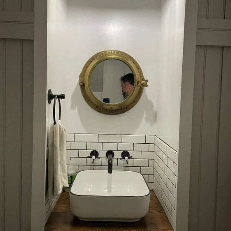 Heavy canal boat porthole mirror showing open and closed position