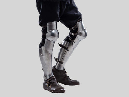 Polished steel leg greaves worn with full knight cosplay armor for LARP event
