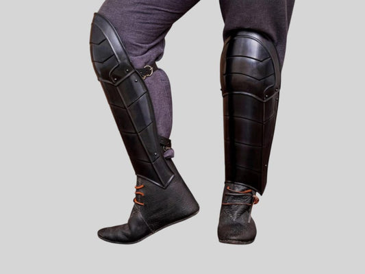 Medieval blackened steel knight armor leg greaves front view for cosplay and LARP use