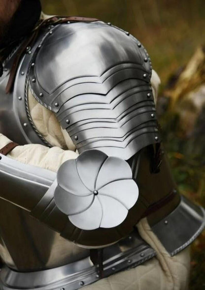 Medieval knight armor with steel pauldrons, couters and arm bracers