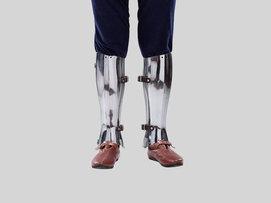 Medieval knight armor closed hinged leg greaves in polished steel finish

