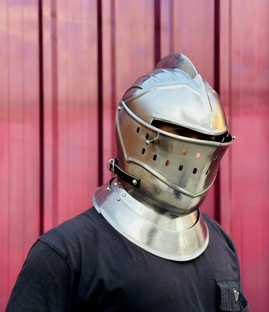 Front view of a medieval European knight closed helmet made of polished steel