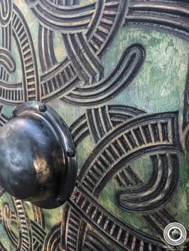 Back side of Viking shield showing leather arm straps for wearable use