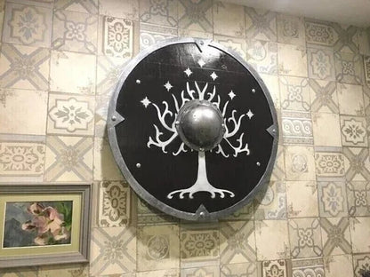 Norse round wooden shield mounted as medieval wall decor with symbolic design