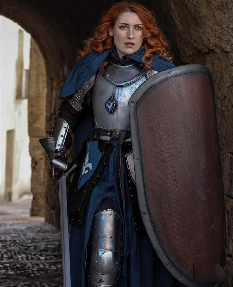 Detailed view showing cuirass, pauldrons, and integrated gorget of the female knight armor, finished in hand-polished steel.

