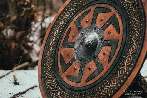 Carved wooden Norse shield displayed as wall decor
