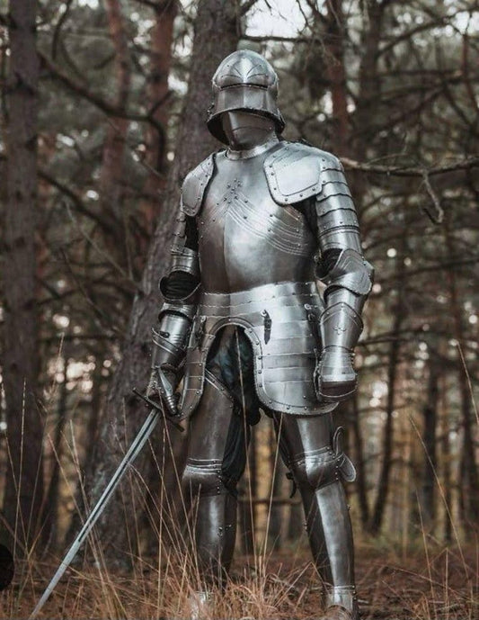 Front view of handcrafted Gothic full plate armor worn by a medieval knight.