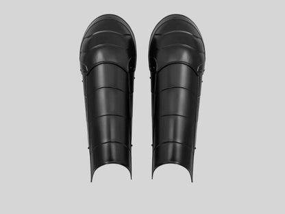 Pair of blackened steel greaves from Lord of Battles, crafted for medieval reenactment

