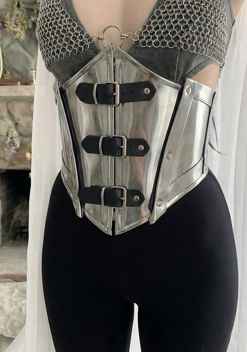 RPG and fantasy cosplay armor, dark elf or warrior queen female knight outfit with chainmail bra and steel corset