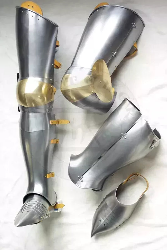 Pair of metallic armor leg guards on a white background