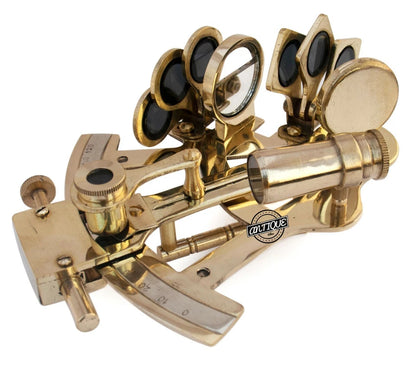 Gold sextant with visible brand logo on a white background