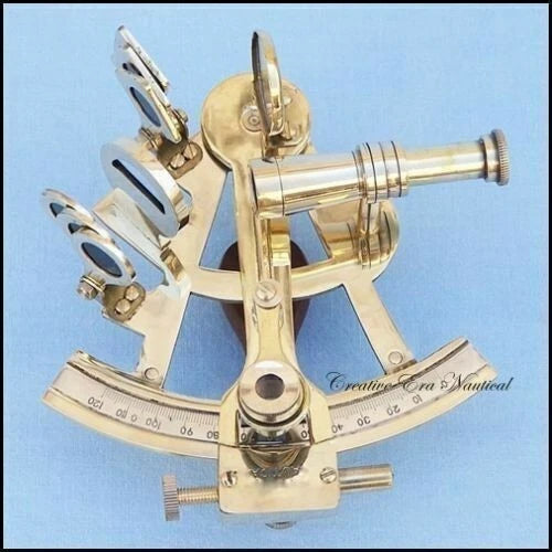Brass sextant on a light blue background with 'Creative Era Nautical' branding.