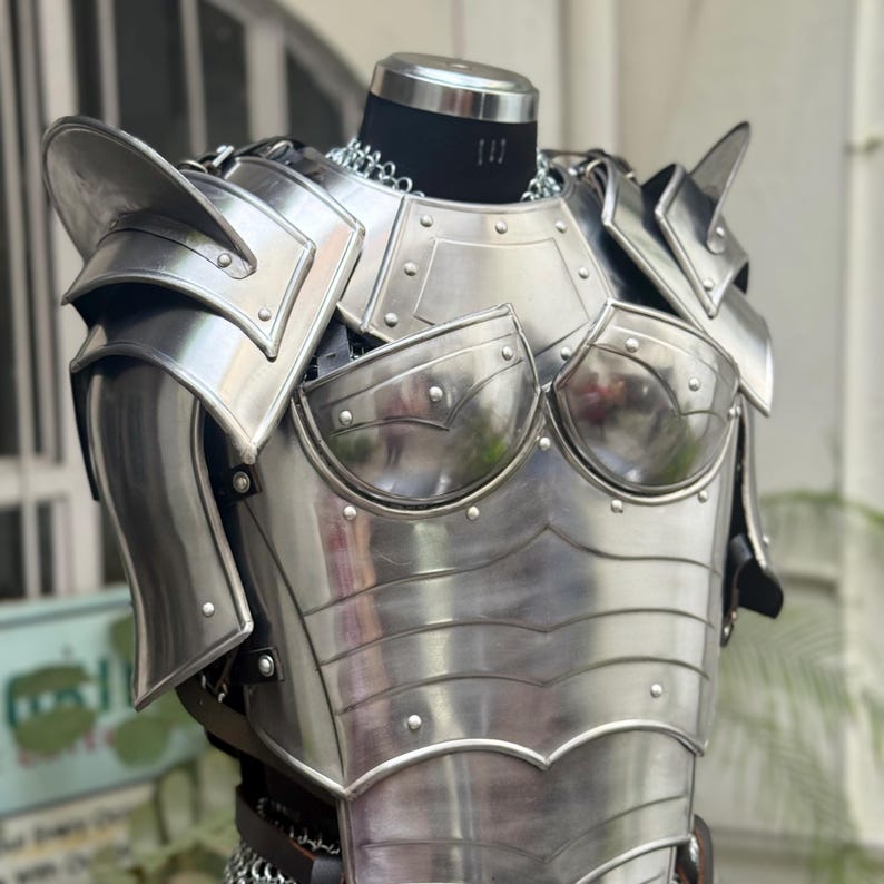 Woman wearing SCA reenactment armor set with detailed shoulder pauldrons and gorget