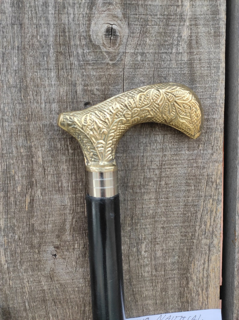 Close-up of Victorian style handle cane with elegant engravings