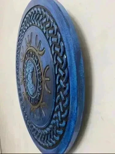 Norse round wooden shield mounted as medieval wall decor display