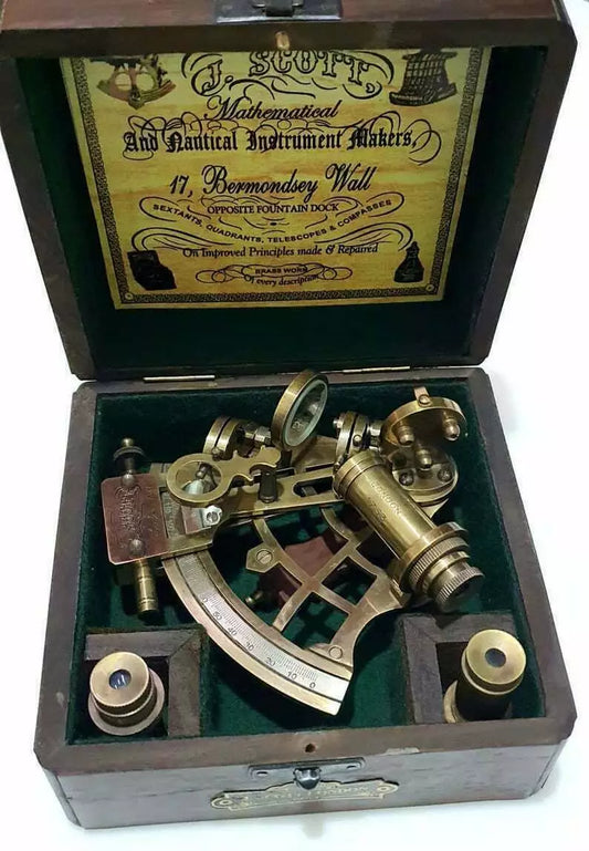 Vintage maritime brass sextant with engraved wooden display and storage box


