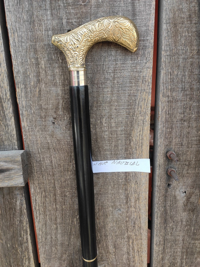 Wooden walking stick featuring polished engraved Derby handle